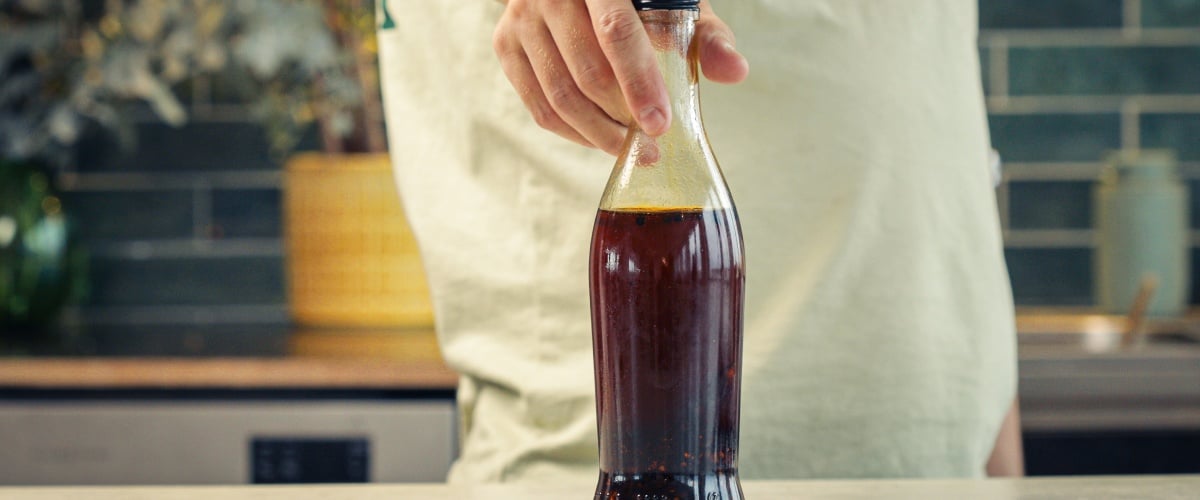 Step 4: Store the Cannabis-Infused Chilli Oil Properly Sealed glass bottle filled with cannabis-infused chilli oil stored for preservation in a kitchen setting